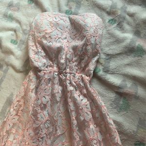 White lace dress with coral color outlines.